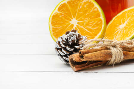 Ingredients for black tea - lemon and cinnamon on a white wooden background.