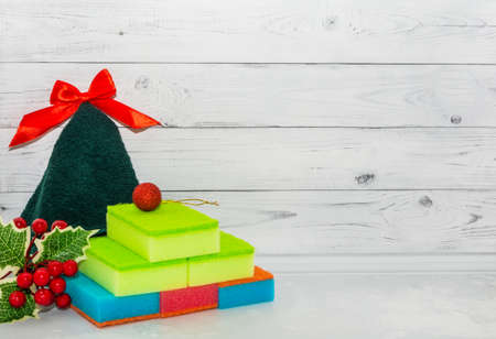 Sponges and towel on a white wooden background. Cleaning products for home and office. Christmas and New Year discounts on cleaning products.の写真素材