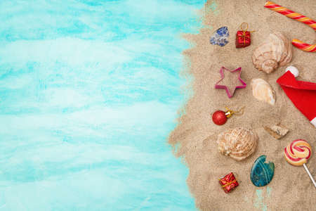 Christmas decorations, gifts, seashells on the sand. Sea travel concept for Christmas holidays. Flat lay.の写真素材