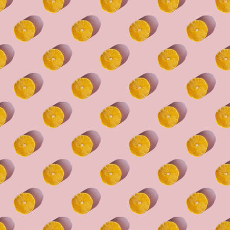 Uniform pattern of dried lemon slices with shadow on a pink background. Flat layの写真素材