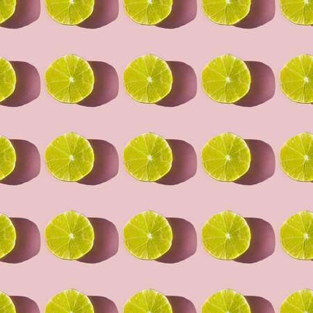 Pattern of dried lime slices with shadow on a pink backgroundの写真素材