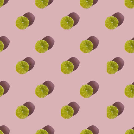 Pattern of dried lime slices with shadow on a pink backgroundの写真素材