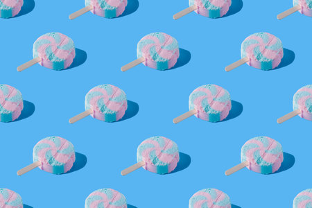 Continuous pattern of ice cream on a stick on a blue background.