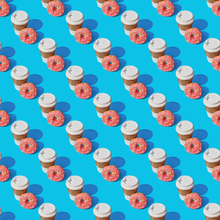 A repeating pattern of a cup of coffee and a red donut on a blue background.の写真素材
