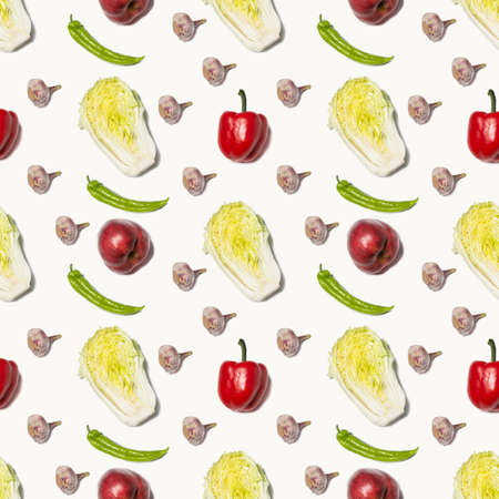 Pattern of fresh vegetables and fruits on a white background. Cabbage, bell pepper and garlic make up a pattern on a white background.の写真素材