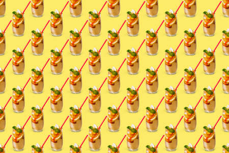 A repeating continuous pattern of a summer drink in a misted glass with slices of lemon and orange...