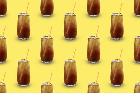 Continuous repeating pattern of a glass of cold iced coffee on a yellow background.