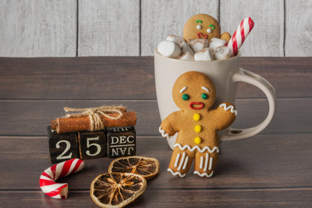 Christmas composition of gingerbread man, coffee, sweets and calendar. New Year and Christmas...