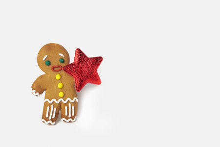 Gingerbread man with a red star on a white isolated background. New Year and Christmas concept....
