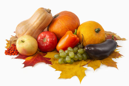 Heap of various vegetables and fruits with pumpkin and maple leaves on a white background. harvest concept. isolated.の写真素材