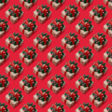 A repeating pattern of a beautiful Christmas present on a red background. view from above. New year...