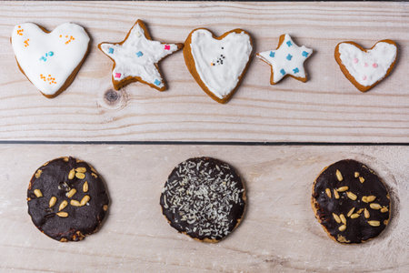 White glazed and brown handmade chocolate gingerbread cookies lie on the table. flat lay.の写真素材