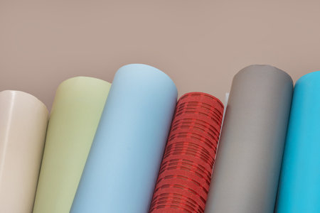 Multi-colored wallpaper prepared for renovation in the room. DIY repair. Rolls of wallpaper as a background.の写真素材