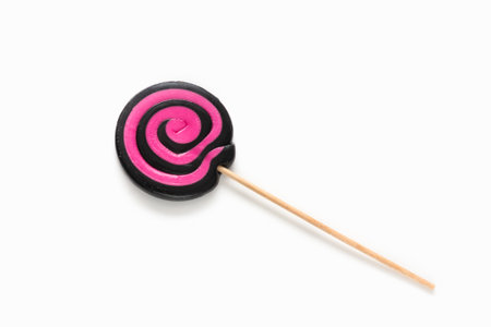 Black and pink lollipop swirl on white isolated background.の写真素材