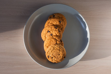 Oatmeal raisin cookies on a gray ceramic plate. Flat layout.