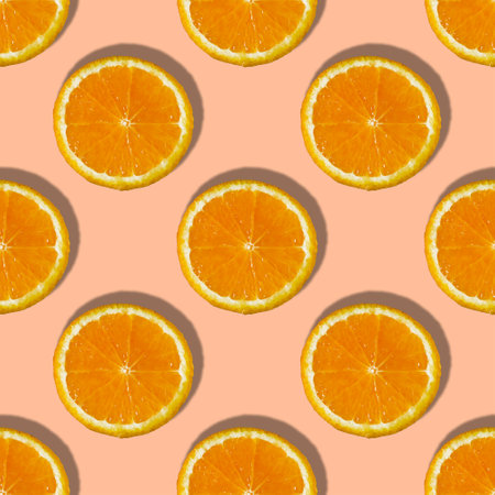 Uniform pattern of orange slices with shadow on peach trendy background. Flat layout.