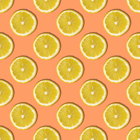 Uniform pattern of lemon slices with shadow on a peach trendy background. Flat layout.