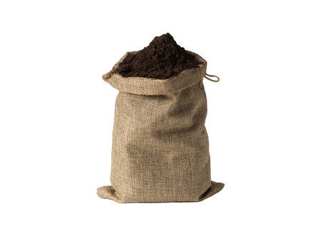 Jute bag with soil mixed with fertilizers on white background. Isolated.の写真素材
