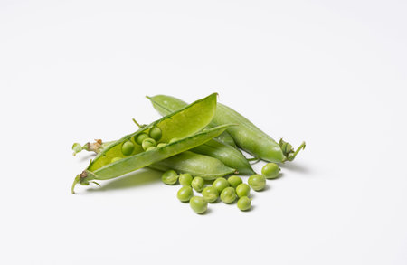 Pods of fresh green peas on a white background. Isolated.