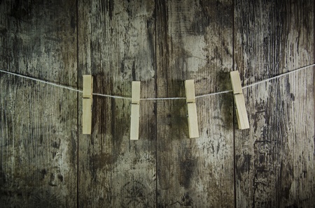 clothes-peg for linen with rope on retro old wooden backgroundの写真素材
