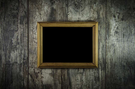 old frame on grunge old wooden background.の写真素材