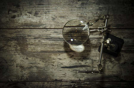Magnifying glass (magnifying glass) on the old wooden tableの写真素材