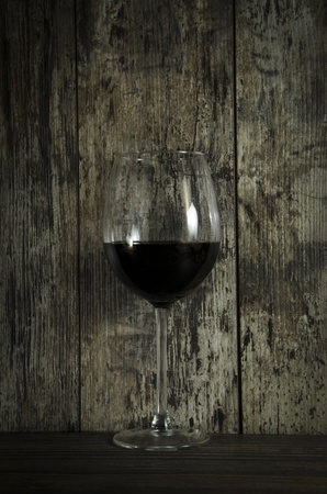 Red wine on old wooden backgroundの写真素材