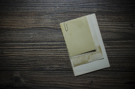 Old sheets of paper (photographs) on a wooden background
