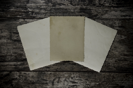 retro old photos on wooden table backgroundの写真素材