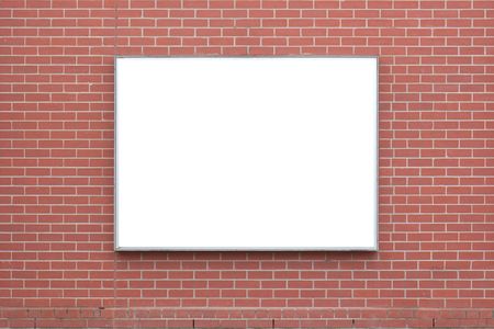 A blank billboard on a red-brick wall.の写真素材