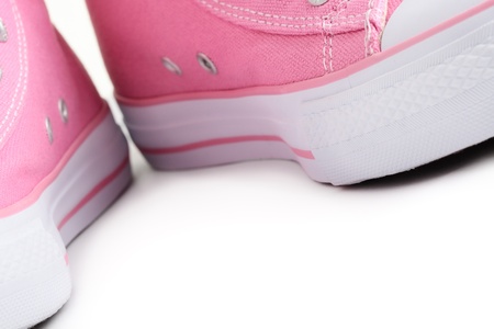 Close-up of a pair of bright pink gym-boots on a white background.の写真素材