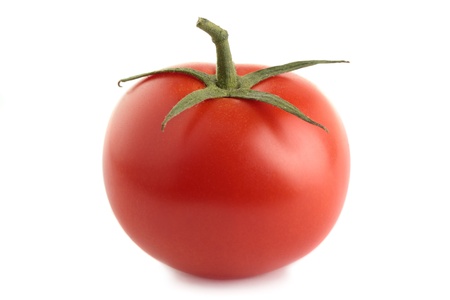 An organic vine-ripened tomato, isolated on a white background.の写真素材