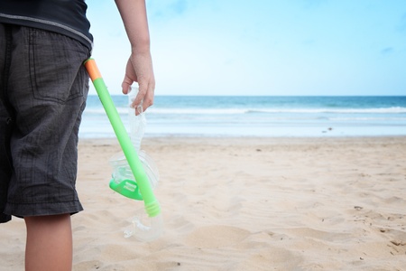 Standing on the beach preparing for snorkeling.の写真素材