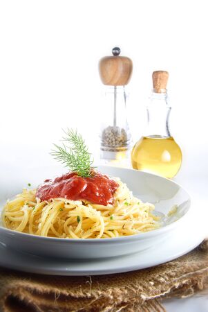 Spaghetti with tomato sauce on unique table setupの写真素材
