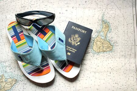 sunglasses, flip flops and a passport on a nautical chartの写真素材