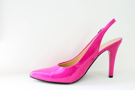 A pink high heeled shoe on a white backgroundの写真素材
