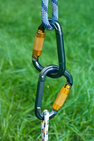 two carabiners on a green grass backgroundの写真素材
