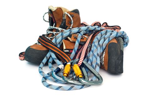 climbing and hiking gear - three carabiners, ropes and leather brown bootsの写真素材
