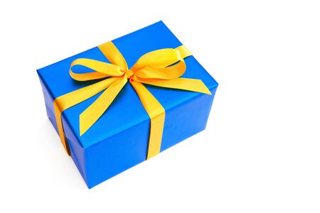 Gift with yellow ribbon isolated on whiteの写真素材