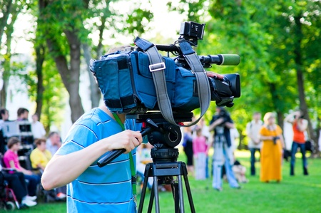 The cameraman filming outdoor event