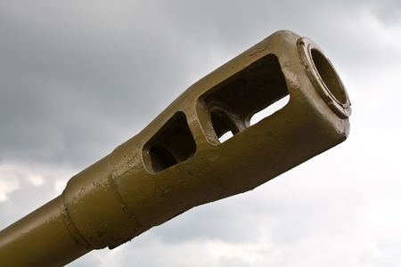Gun of the tank against cloudy skyの写真素材