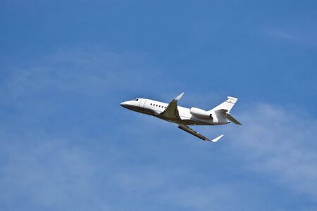 Private jet in the blue skyの写真素材