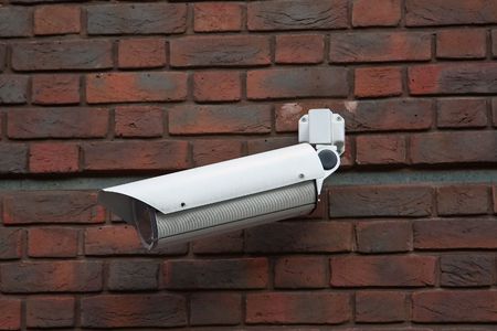 Surveillance camera on the brick wall