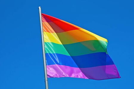 Rainbow flag gainst blue sky