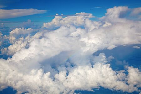 Beautiful cloudscape with fluffy cirrus clouds and rainbowの写真素材