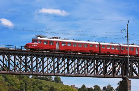 Old swiss train on the bridge over Rhine river