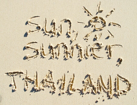 simple sun drawing on the sand on the beachの写真素材