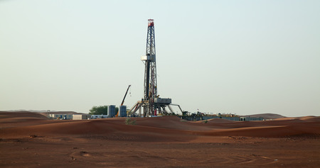 Oil derrick in the red sand "Arabian desert" near Dubai, United Arab Emiratesのeditorial素材