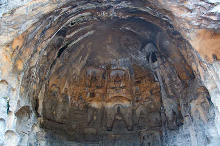 Famous Longmen Grottoes (statues of Buddha and Bodhisattvas carved in the monolith rock near Luoyang...