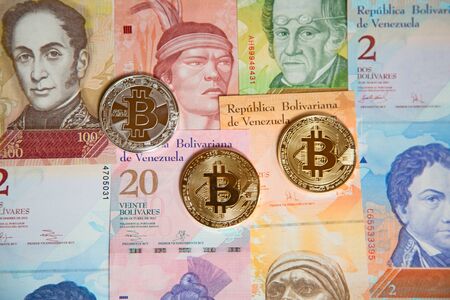 Bitcoins over the background made of Venezuela currency